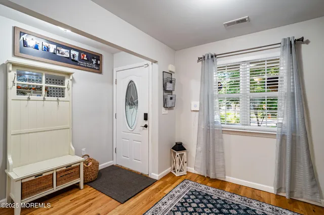 a view of a livingroom with furniture and a window