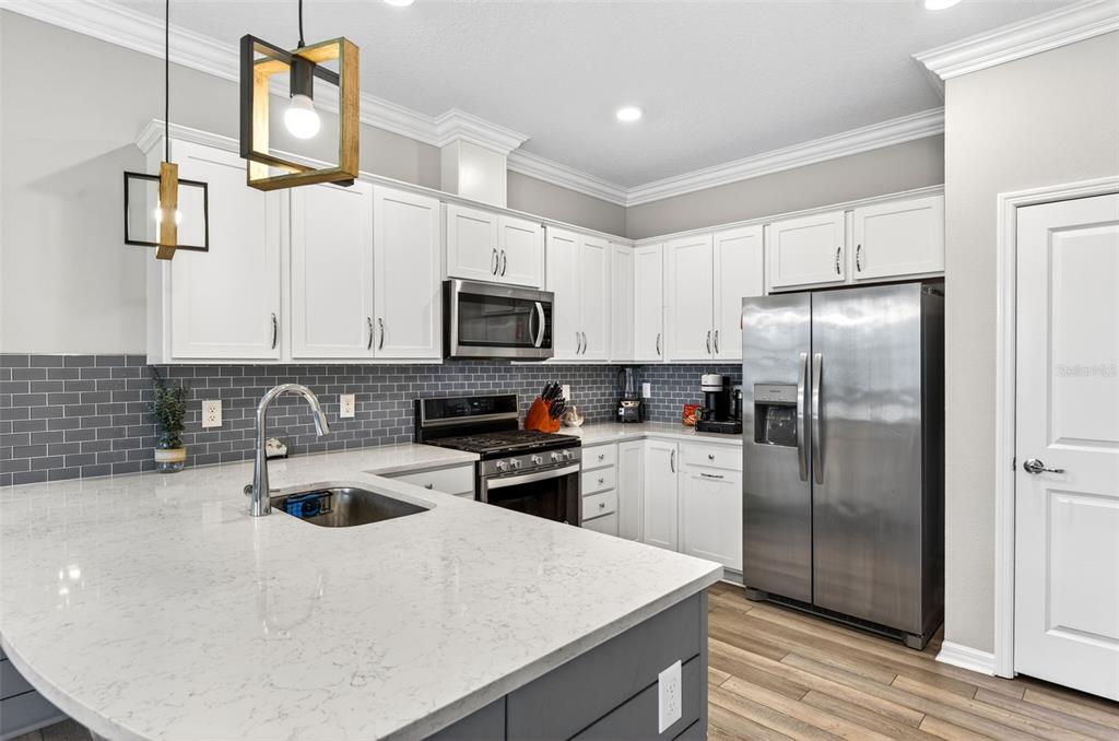6427 Mooring Line Circle Apollo Beach, FL 33572 - Photo 5 of 34 a kitchen with a refrigerator a stove sink and microwave