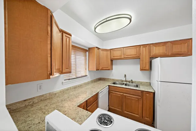 a kitchen with a refrigerator and a sink