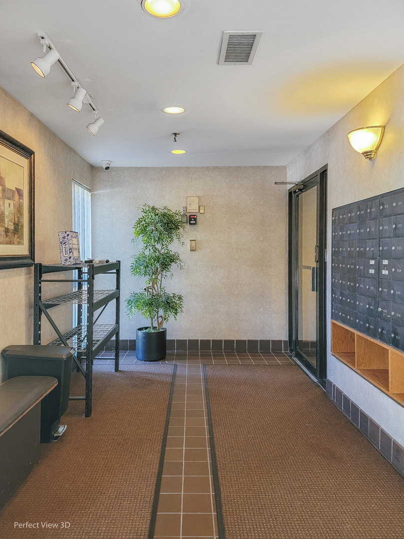701 Forum Square, Unit 307 Glenview, IL 60025 - Photo 20 of 22 a lobby with furniture and potted plant