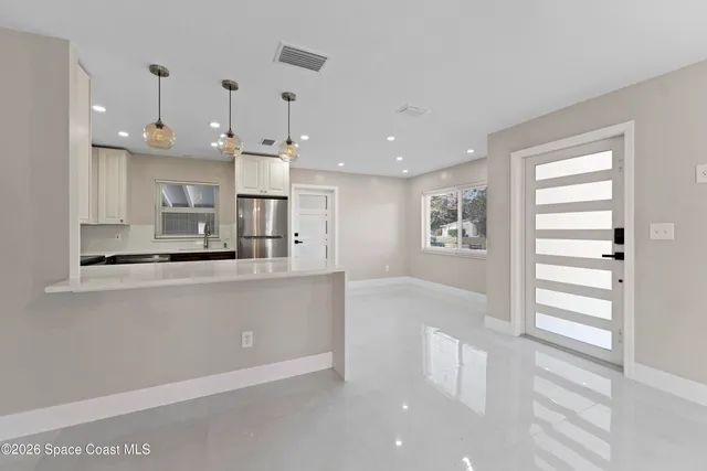 a living room with kitchen island furniture and a window