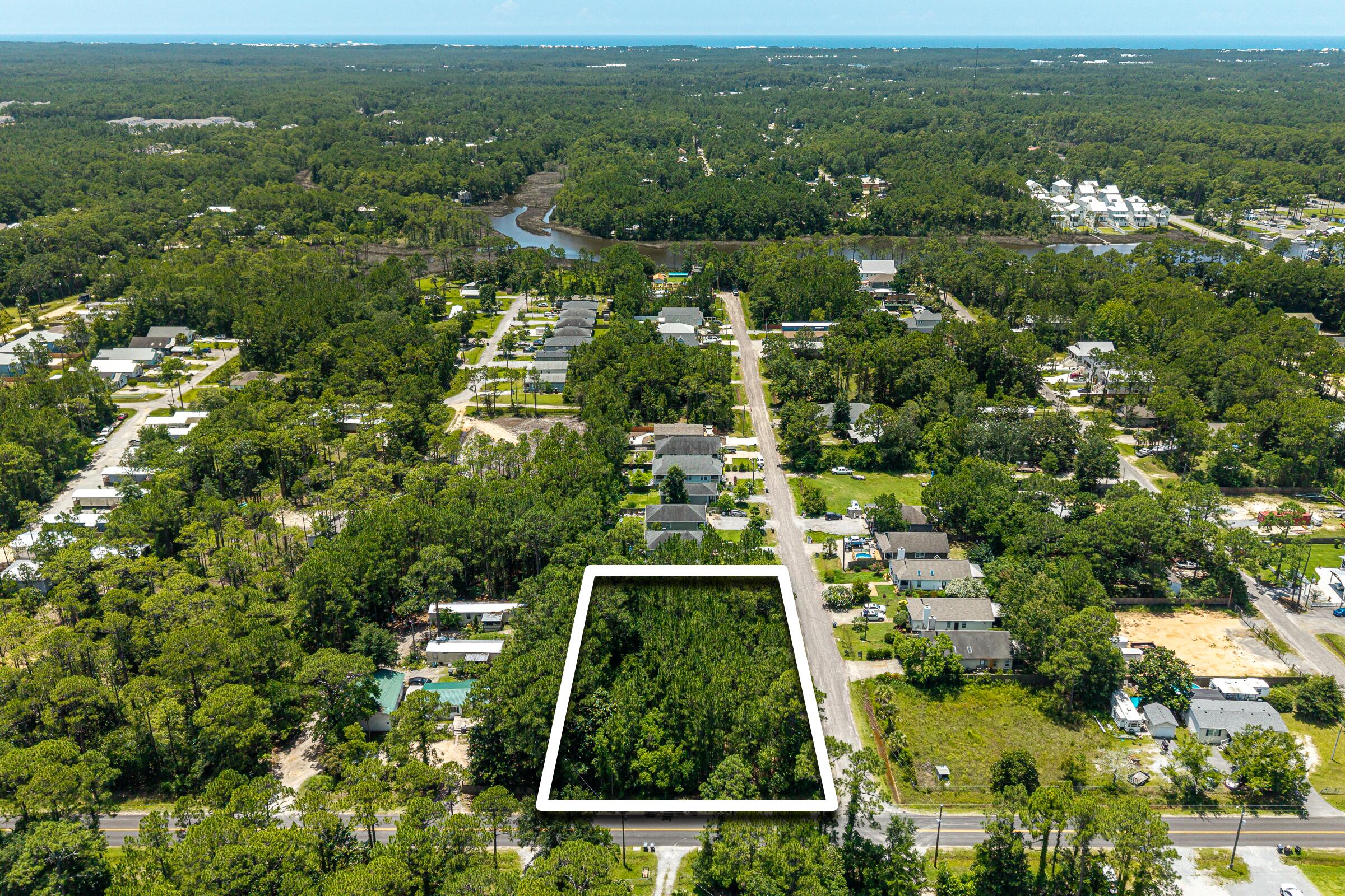 209 East Nursery Road Santa Rosa Beach, FL 32459 - Photo 3 of 11 an aerial view of residential houses with outdoor space and trees