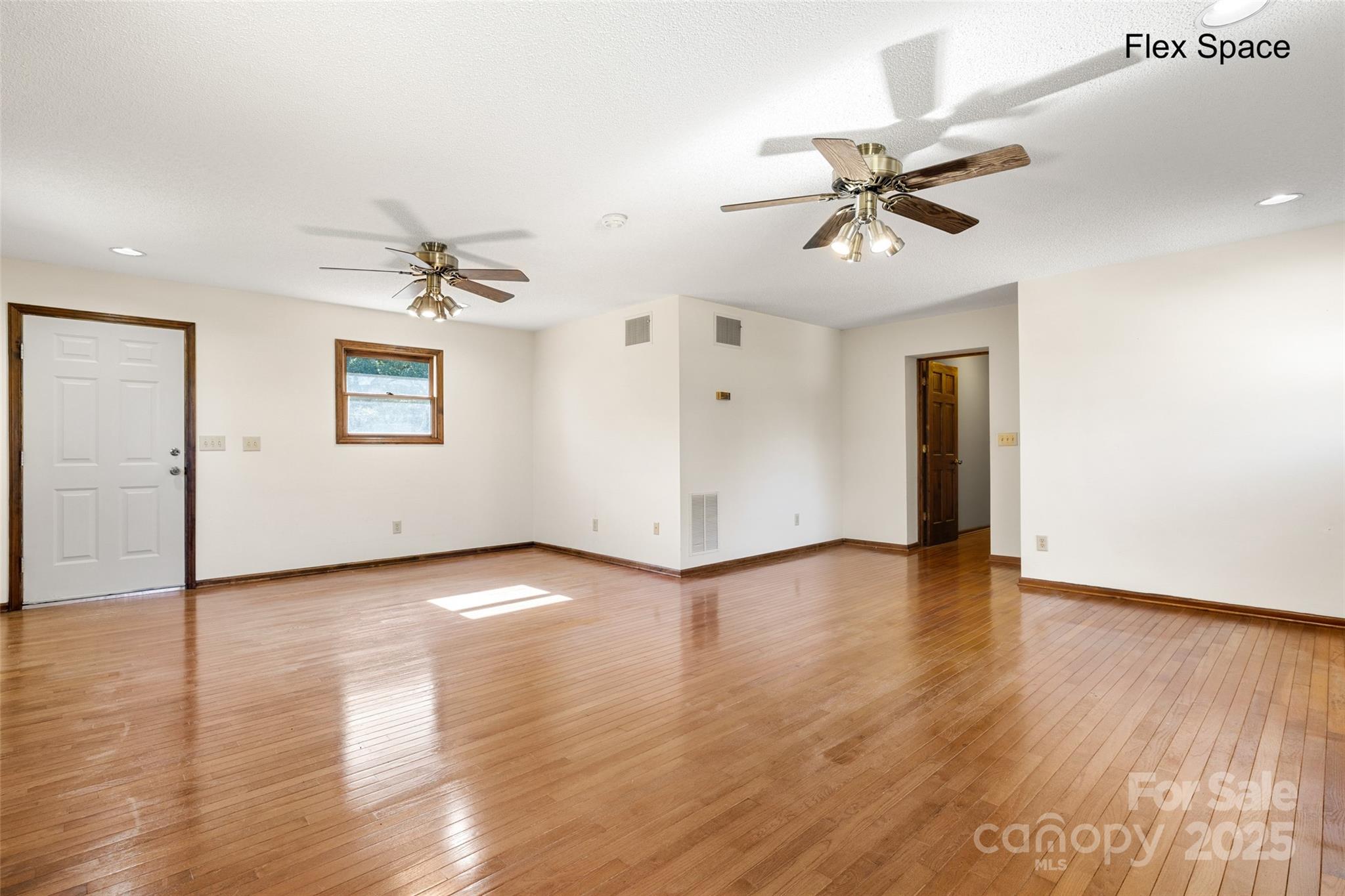 5303 Rogers Road Monroe, NC 28110 - Photo 20 of 45 wooden floor in an empty room with a window