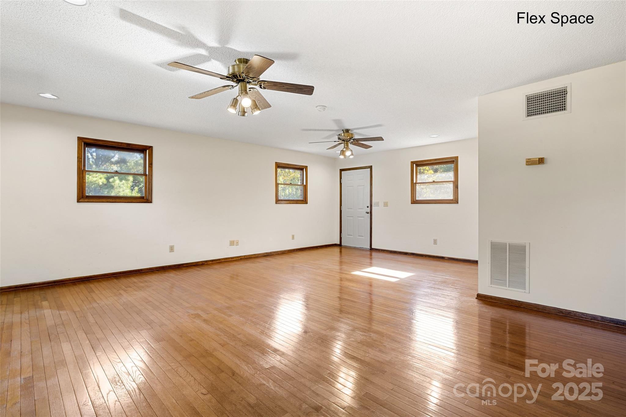 5303 Rogers Road Monroe, NC 28110 - Photo 21 of 45 a view of an empty room with wooden floor and a window