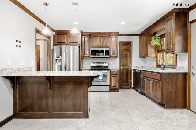 a kitchen with stainless steel appliances granite countertop a stove and cabinets