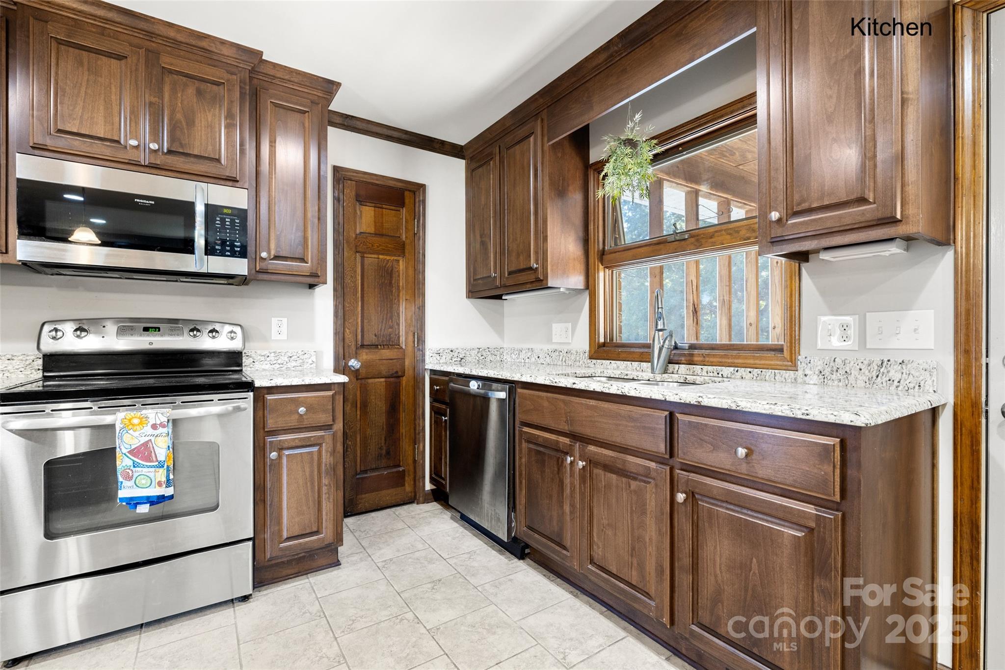 5303 Rogers Road Monroe, NC 28110 - Photo 9 of 45 a kitchen with stainless steel appliances granite countertop a stove microwave and refrigerator
