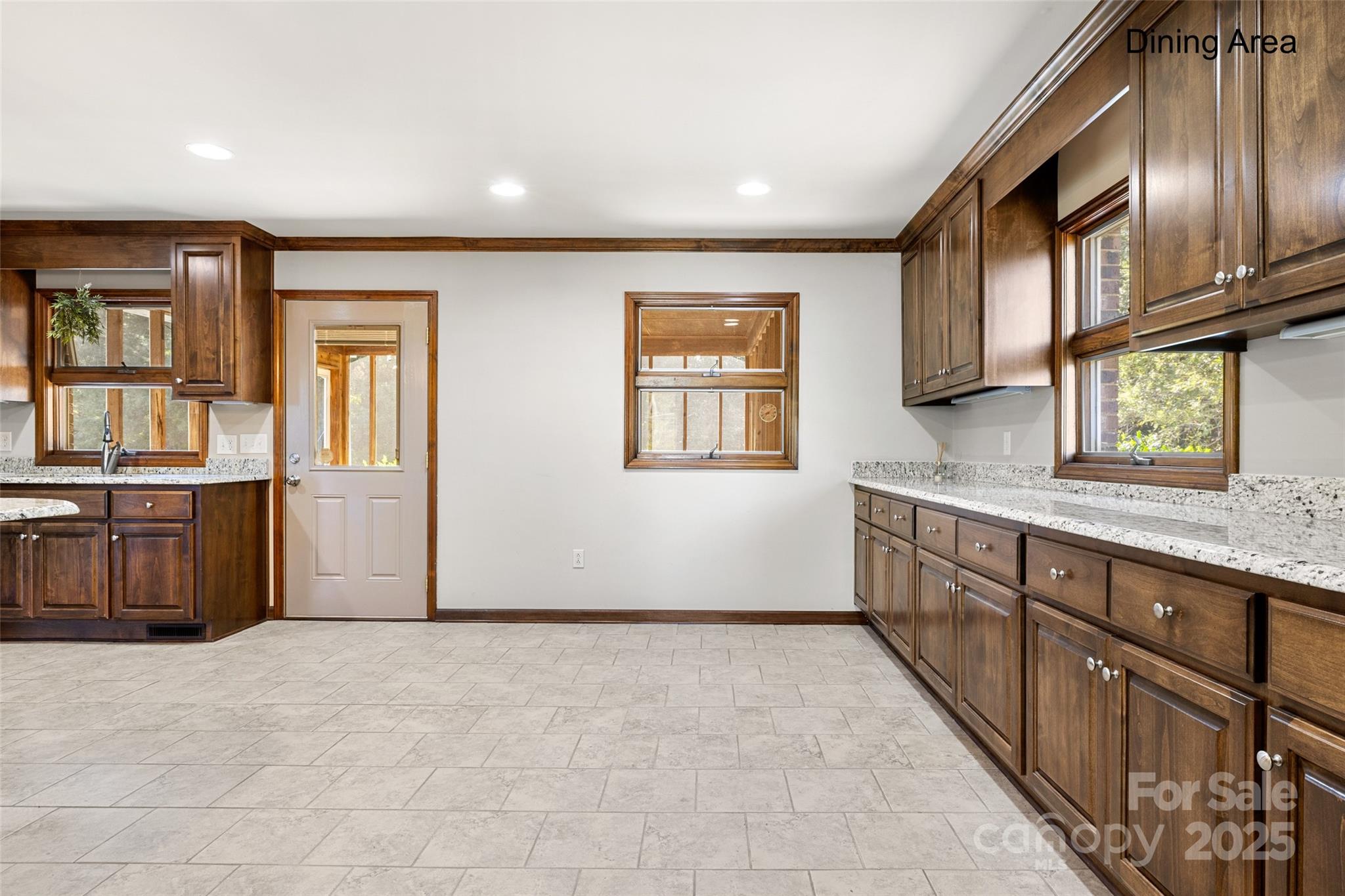 5303 Rogers Road Monroe, NC 28110 - Photo 10 of 45 a view of a kitchen with granite countertop a sink and dishwasher a oven with wooden cabinets