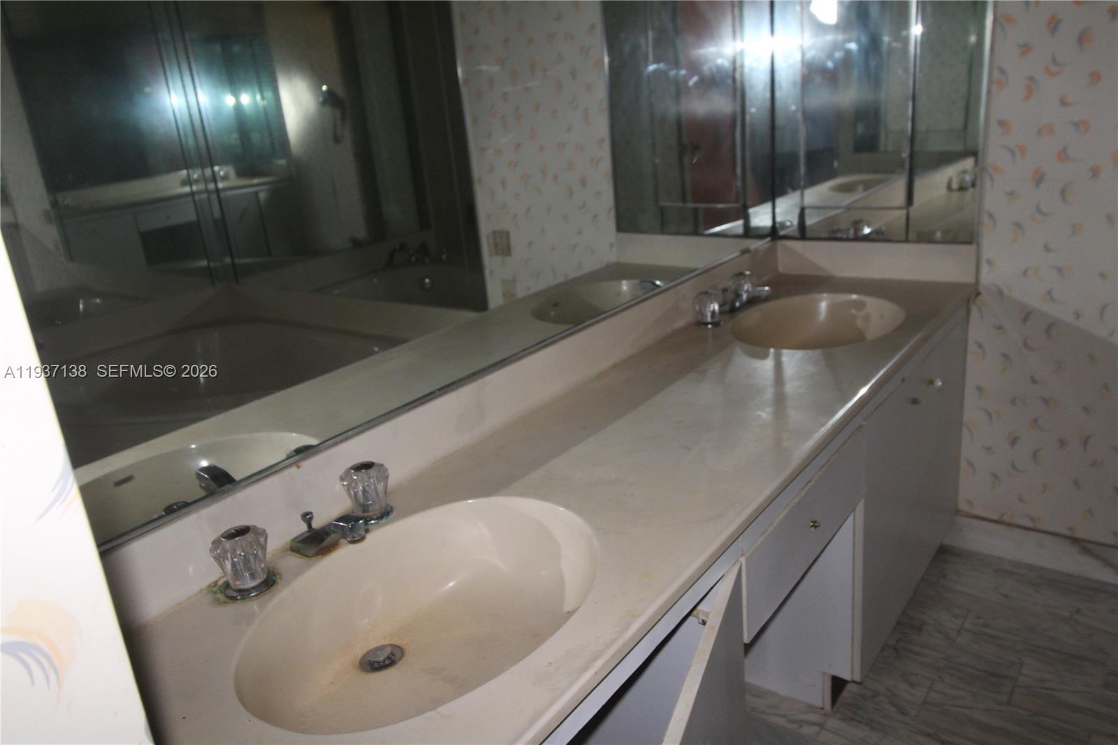 1000 Quayside Terrace, Unit 1807 Miami, FL 33138 - Photo 16 of 21 a bathroom with a sink and mirror