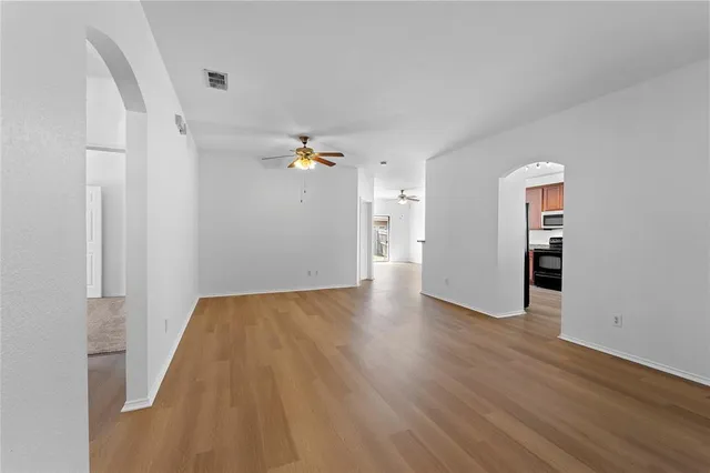 an empty room with wooden floor and closet