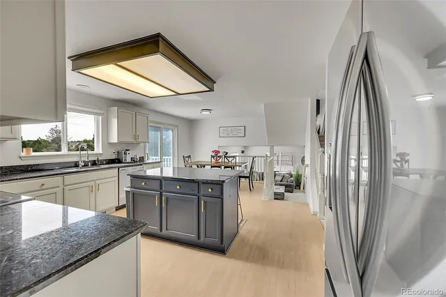 a kitchen with stainless steel appliances granite countertop a refrigerator and a sink