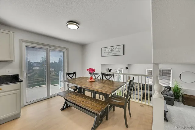 a dining room with furniture and a floor to ceiling window