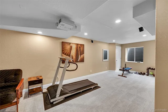 a room with gym equipment and windows