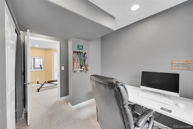 a workspace with furniture and a gate