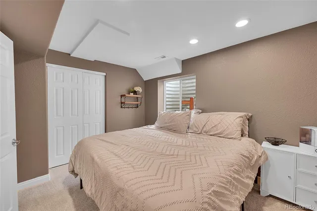 a bedroom with a bed and a closet