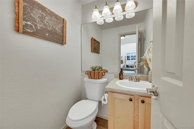 a bathroom with a toilet a sink and a mirror