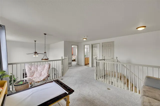 a view of a hallway with seating area