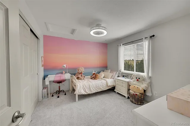 a bedroom with furniture and a large window