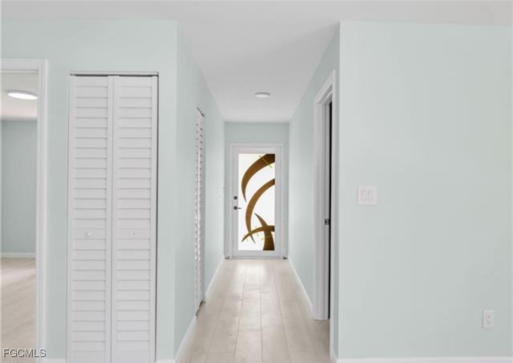 16320 Arbor Ridge Drive Fort Myers, FL 33908 - Photo 11 of 20 a view of a hallway with wooden floor and natural light