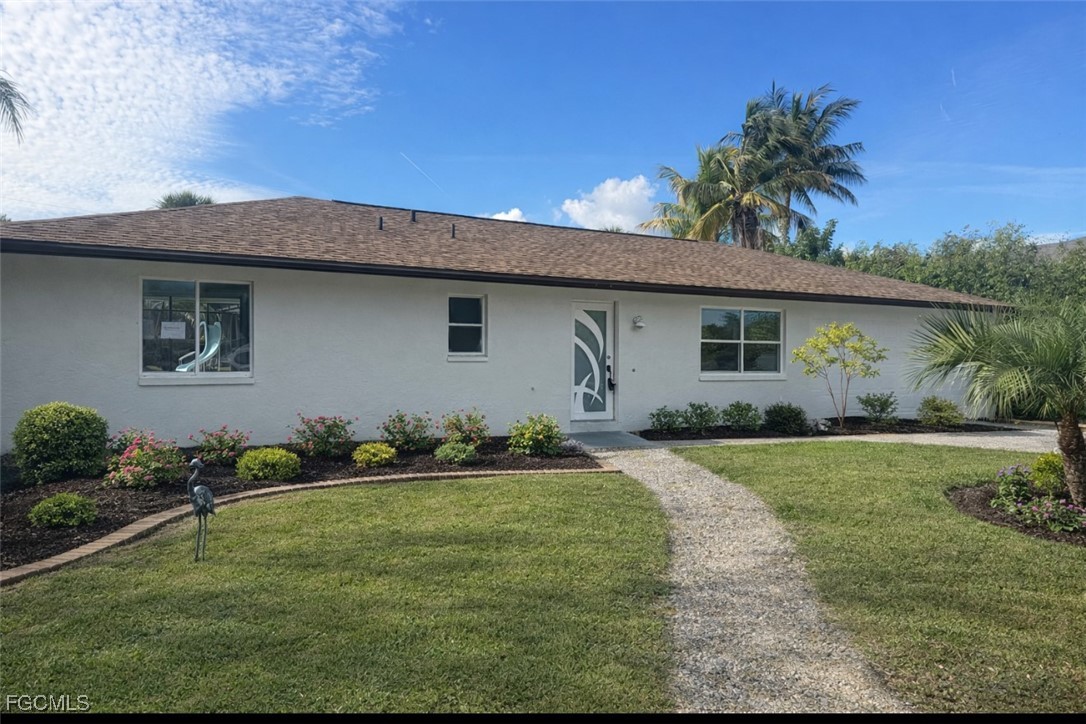 16320 Arbor Ridge Drive Fort Myers, FL 33908 - Photo 2 of 20 a front view of house with yard and outdoor seating