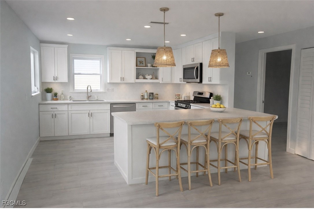16320 Arbor Ridge Drive Fort Myers, FL 33908 - Photo 5 of 20 a kitchen with cabinets a sink and chairs in it
