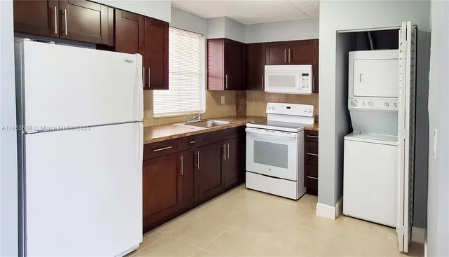 a white refrigerator freezer sitting in a kitchen