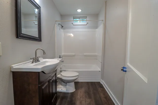 a bathroom with a sink toilet a mirror and shower