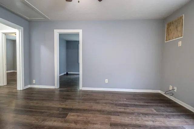 a view of room with window and wooden floor