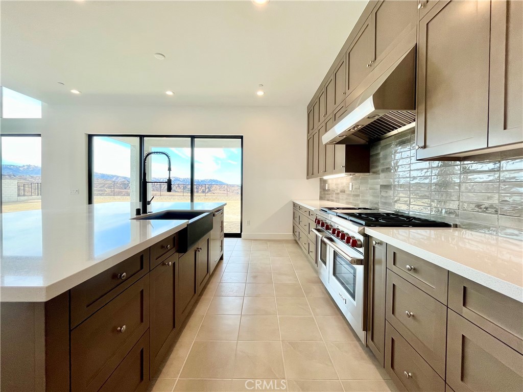 27565 Elderberry Drive Valencia, CA 91381 - Photo 11 of 36 a large kitchen with stainless steel appliances granite countertop a lot of counter space and a sink