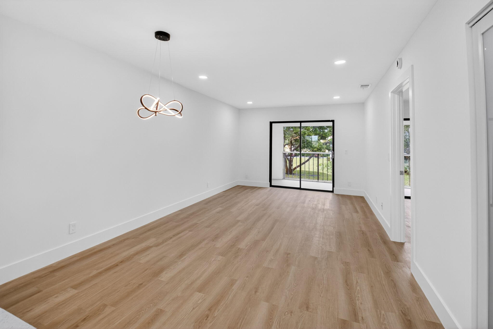 300 West Hidden Valley Boulevard, Unit 308 Boca Raton, FL 33487 - Photo 11 of 39 wooden floor in an empty room with a window