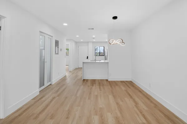 a view of a kitchen with wooden floor and a sink