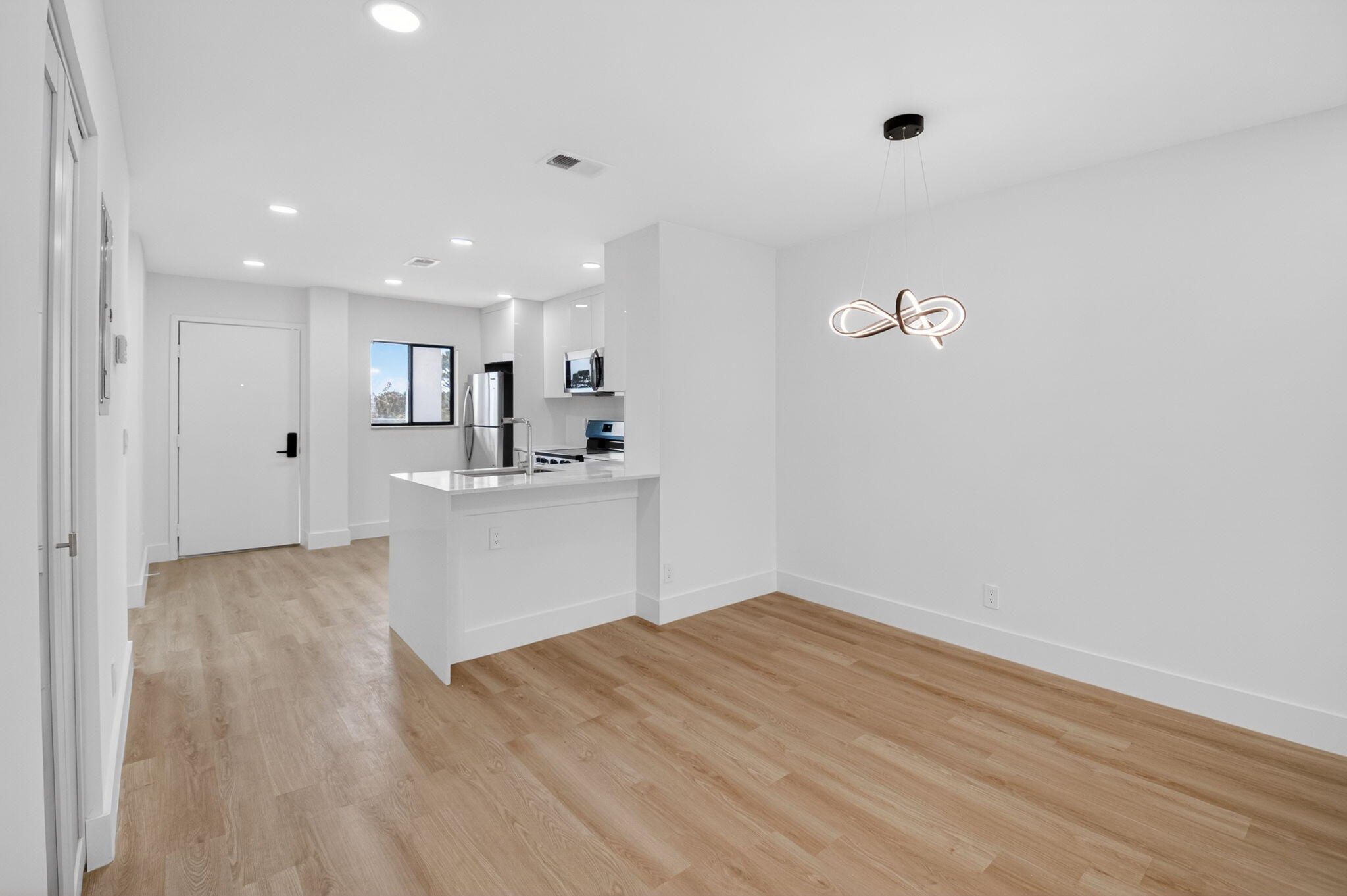 300 West Hidden Valley Boulevard, Unit 308 Boca Raton, FL 33487 - Photo 14 of 39 a view of a kitchen with wooden floor and a sink