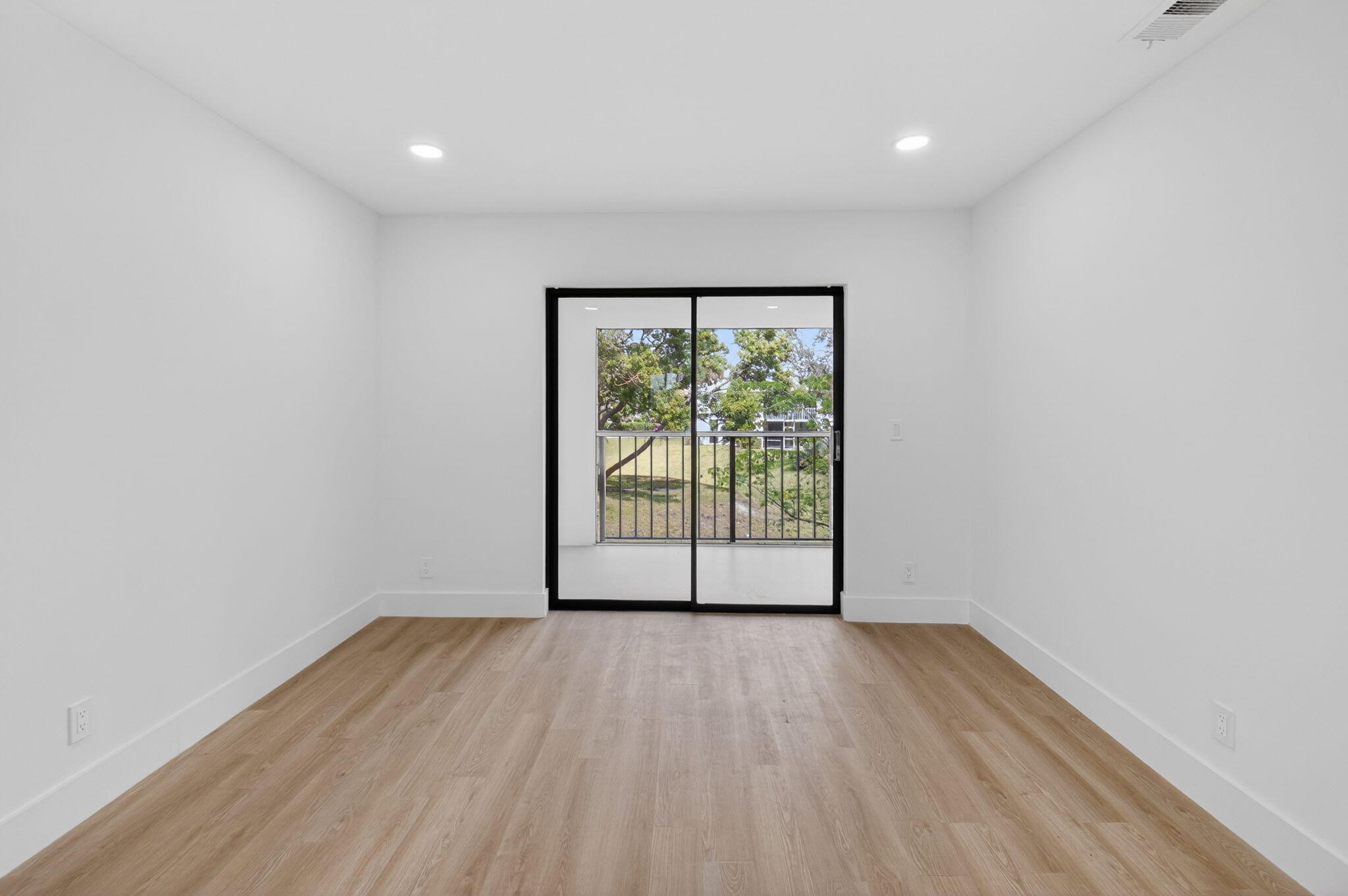 300 West Hidden Valley Boulevard, Unit 308 Boca Raton, FL 33487 - Photo 15 of 39 a view of an empty room with wooden floor and a window