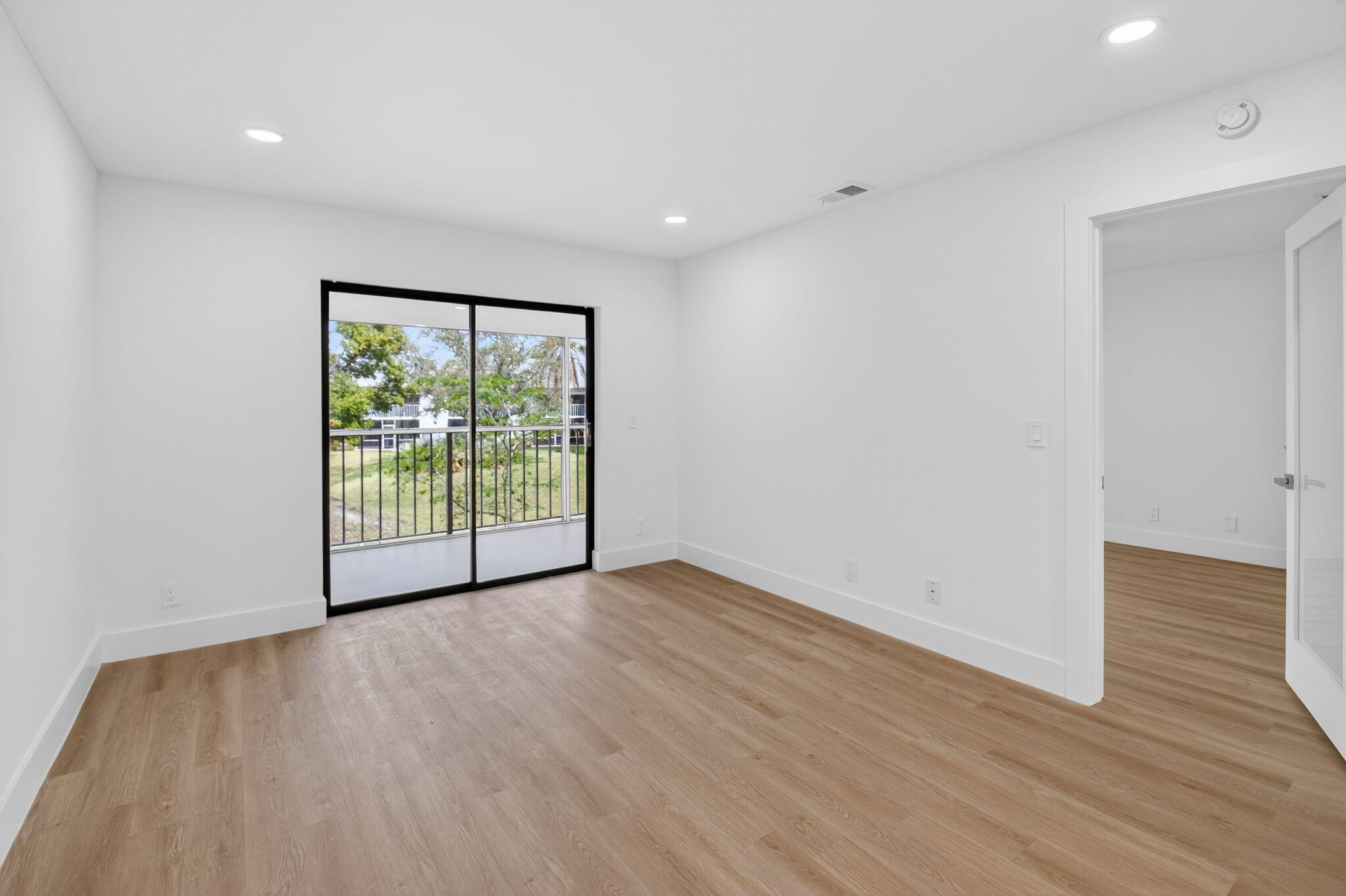 300 West Hidden Valley Boulevard, Unit 308 Boca Raton, FL 33487 - Photo 16 of 39 a view of an empty room with wooden floor and a window