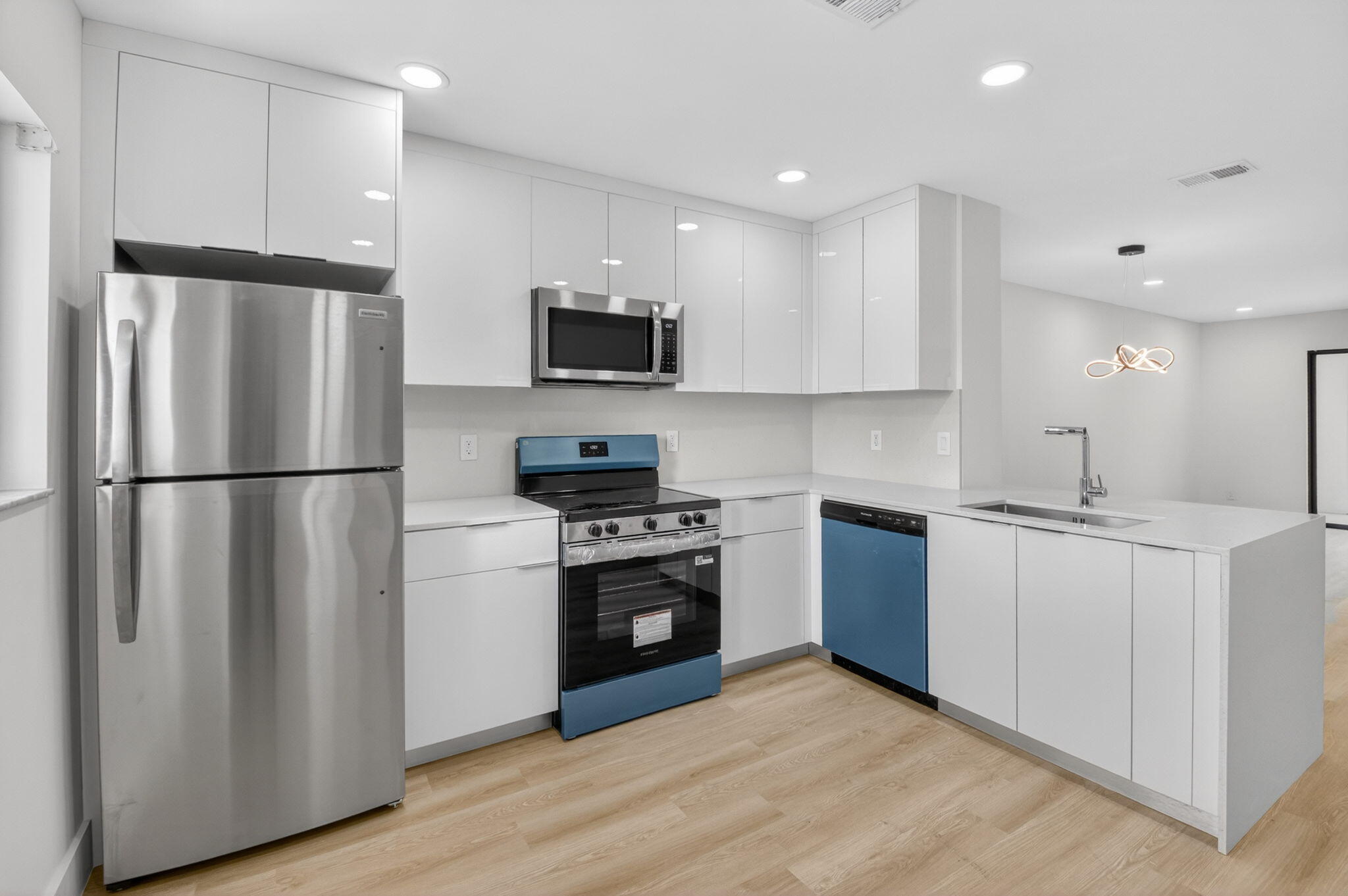 300 West Hidden Valley Boulevard, Unit 308 Boca Raton, FL 33487 - Photo 2 of 39 a kitchen with stainless steel appliances a refrigerator stove a sink and a microwave