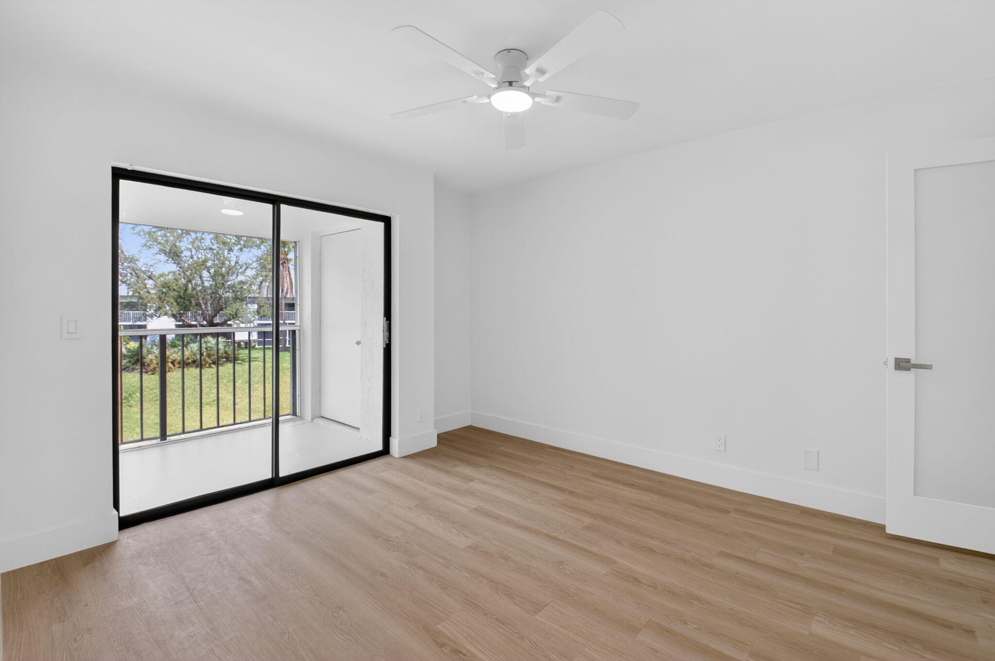 300 West Hidden Valley Boulevard, Unit 308 Boca Raton, FL 33487 - Photo 21 of 39 wooden floor in an empty room with a window