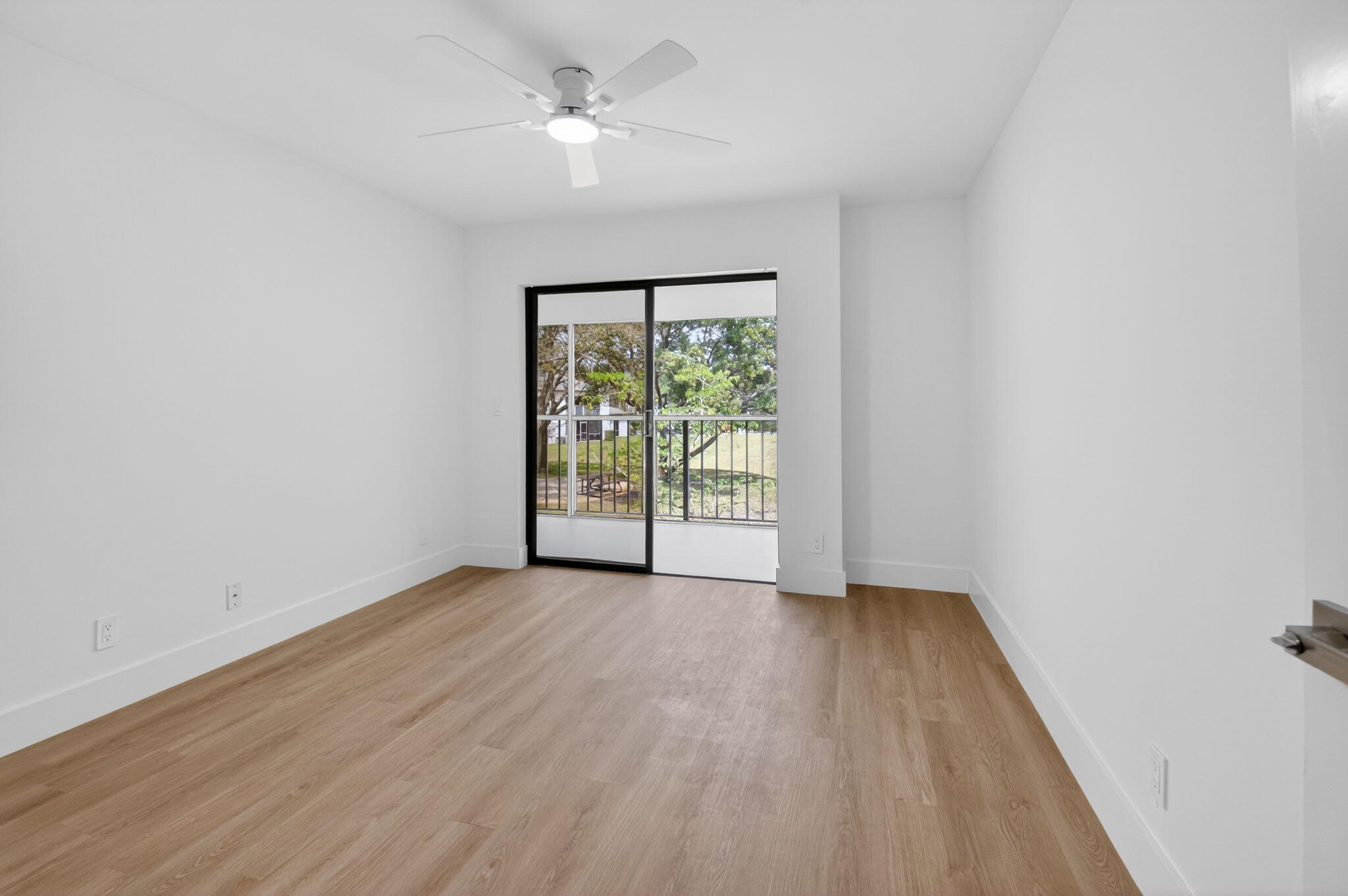 300 West Hidden Valley Boulevard, Unit 308 Boca Raton, FL 33487 - Photo 28 of 39 an empty room with wooden floor fan and windows