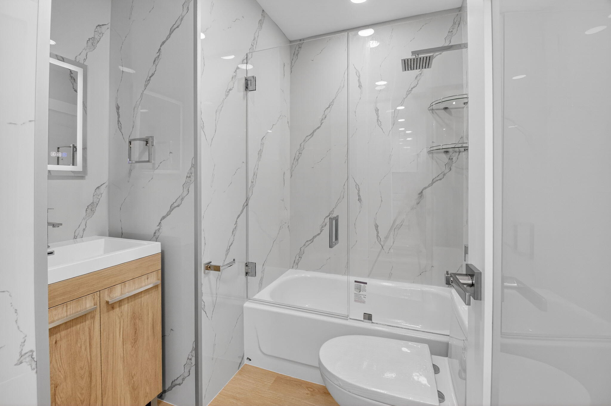 300 West Hidden Valley Boulevard, Unit 308 Boca Raton, FL 33487 - Photo 32 of 39 a bathroom with a sink a toilet and shower