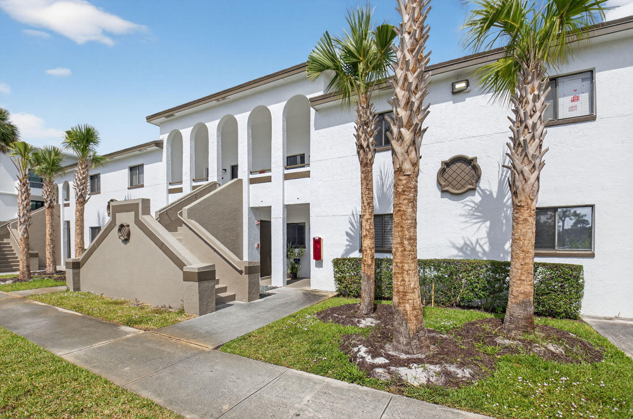 300 West Hidden Valley Boulevard, Unit 308 Boca Raton, FL 33487 - Photo 38 of 39 a front view of a house with a yard