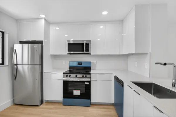 a kitchen with a refrigerator stove and microwave