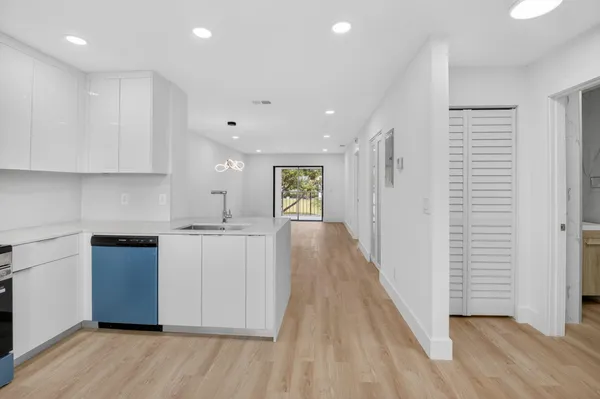 a kitchen with a refrigerator and a stove top oven