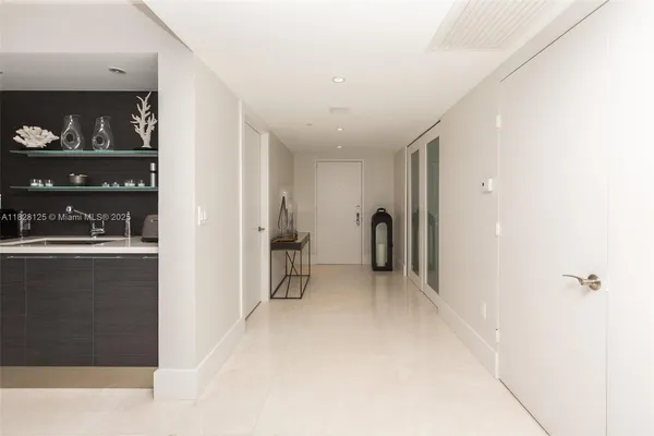 a bedroom with a bed a chandelier and a mirror