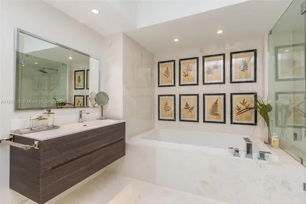 a bedroom with a bed and a flat tv screen on dresser