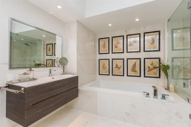 a bedroom with a bed and a flat tv screen on dresser