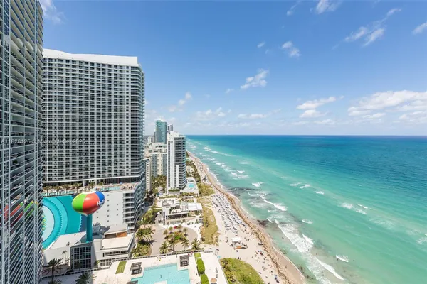 a living room with furniture a large window and a flat screen tv