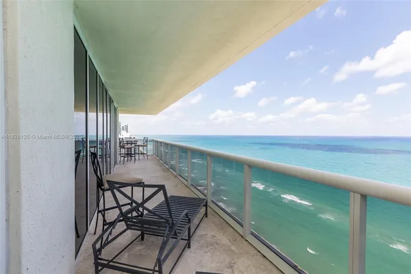 a view of balcony with two chairs and a table