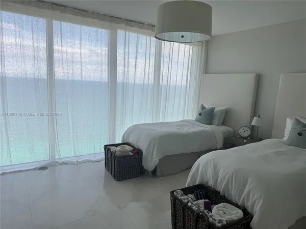 a living room with stainless steel appliances kitchen island a stove a sink dishwasher and white cabinets