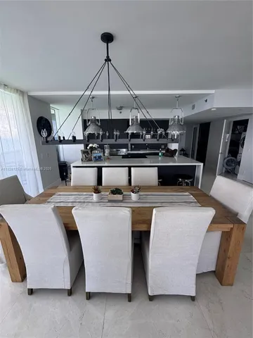 a kitchen with a sink a stove top oven and white cabinets