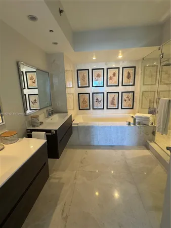 a spacious bedroom with a bed and a chandelier