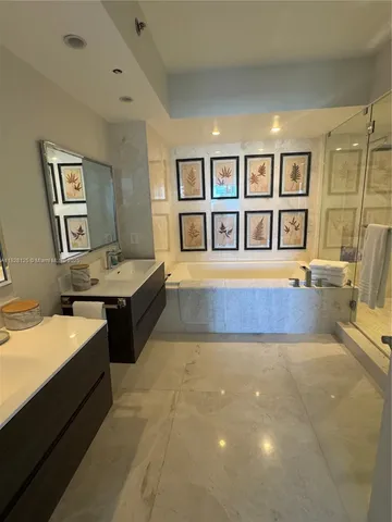 a spacious bedroom with a bed and a chandelier