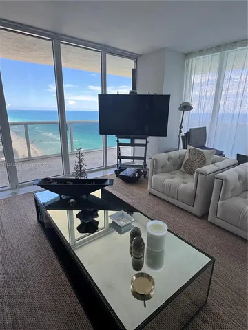 a living room with a couch and a chandelier